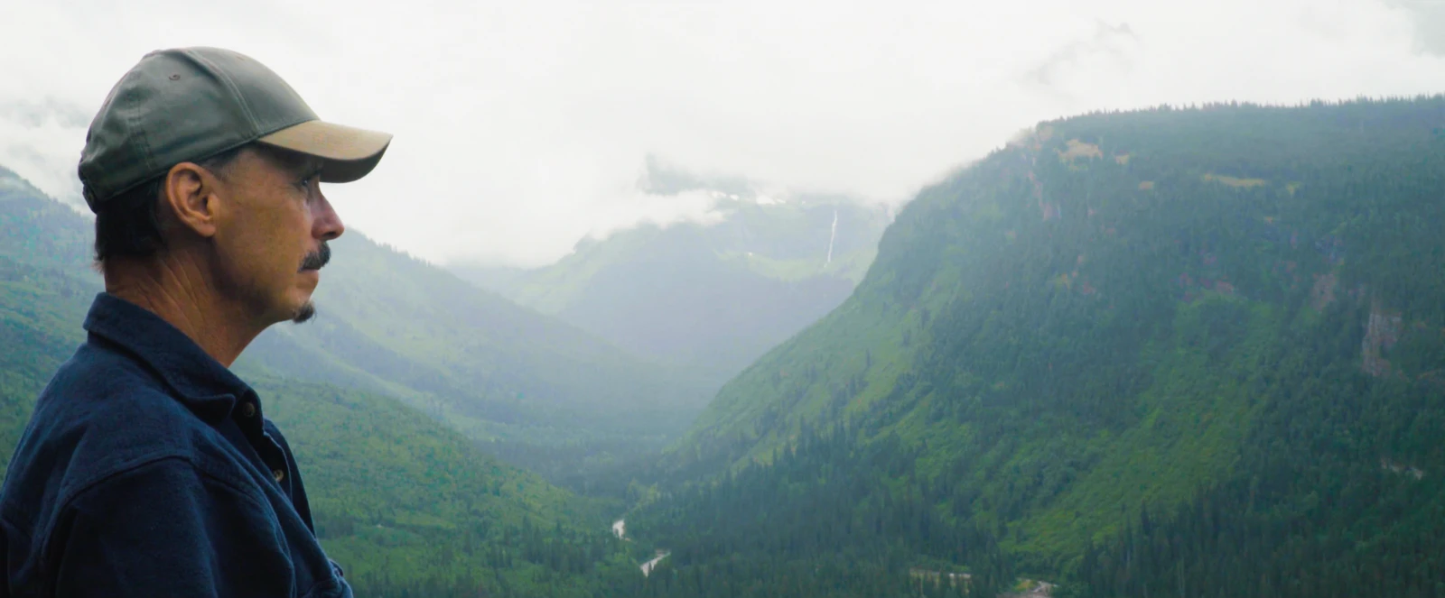 Patrick Rogers overlooking a mountain valley in Glacier National Park, Montana